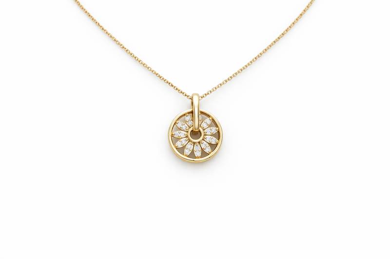 Gold necklace with a round pendant on a white background