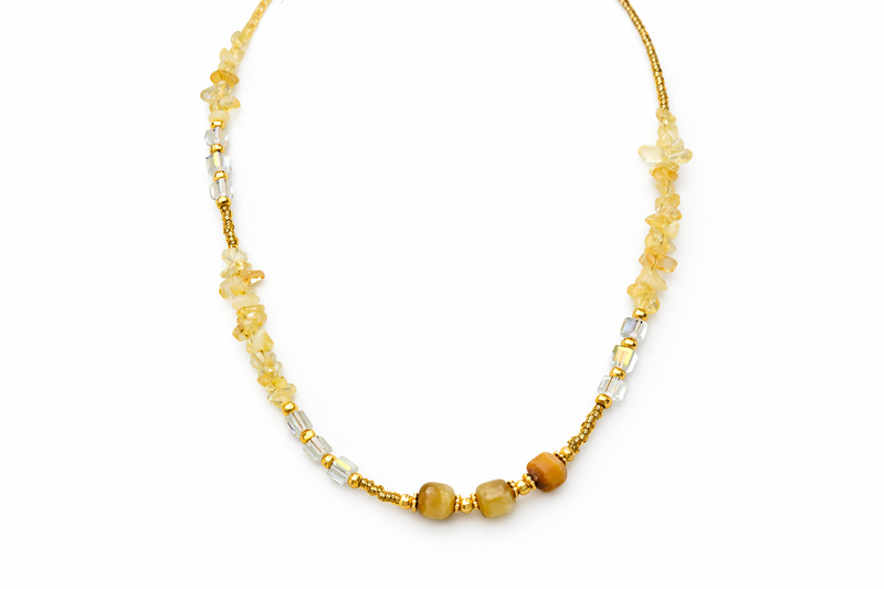 Necklace with yellow and white beads on a white background
