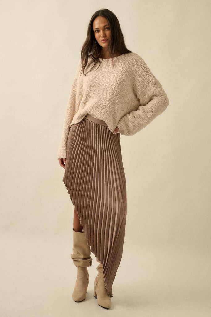 Brown asymmetric pleated skirt with flowing high-low hem.