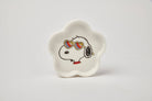 Flower-shaped ceramic trinket dish featuring a black-and-white beagle wearing rainbow heart sunglasses, paired with a teal gift box.