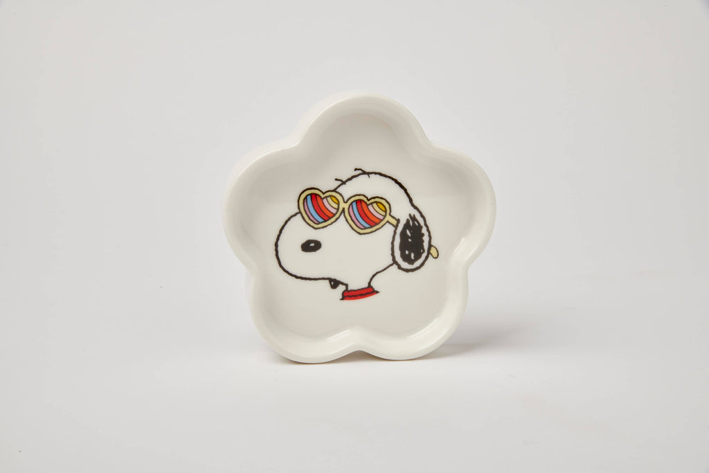 Flower-shaped ceramic trinket dish featuring a black-and-white beagle wearing rainbow heart sunglasses, paired with a teal gift box.