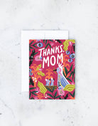  A colorful “Thanks Mom” card featuring vibrant floral and bird illustrations on a bright background.