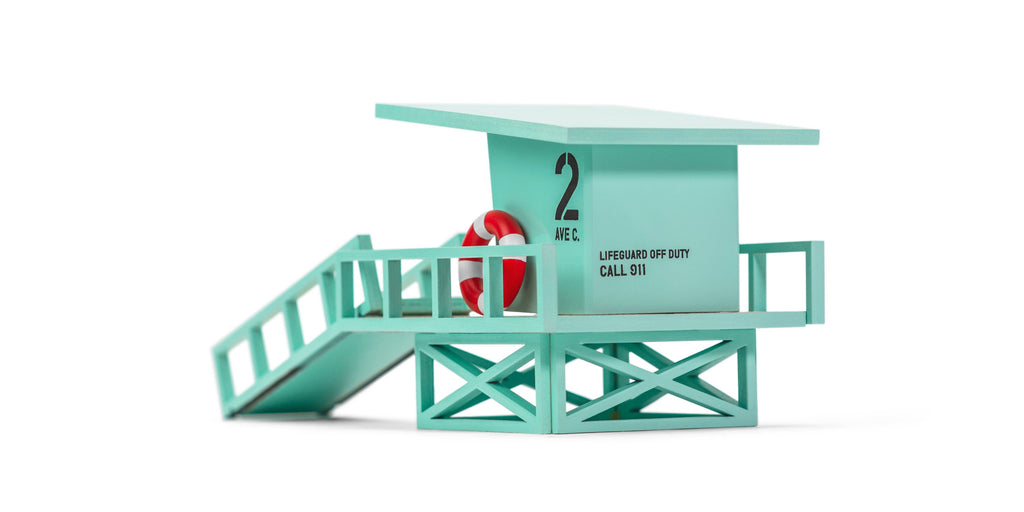 Toy lifeguard stand with a figure on a white background