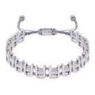 A silver-colored bracelet with adjustable ends and intricate design, featuring a mix of bronze and silver materials.