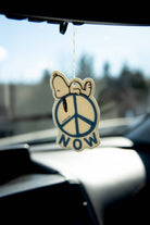 Peanuts® Snoopy Peace Now Air Freshener with fresh linen scent, featuring Snoopy resting on a peace sign.