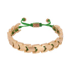 A bronze bracelet with green and gold color scheme, featuring intricate patterns and adjustable ends.