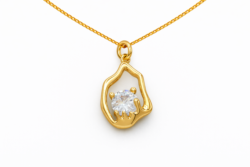 Gold pendant with a diamond on a white background