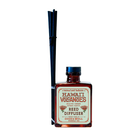 Hawai‘i Volcanoes reed diffuser with amber bottle and black reeds by Good & Well Supply Co., featuring wild fig, ginger, and citrus.