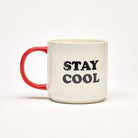White ceramic mug with a red handle featuring a relaxed character in sunglasses and the phrase "Stay Cool" in bold lettering.