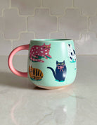 FORMA Ceramic Cats Mug - Whimsical cat illustrations for charming coffee moments.