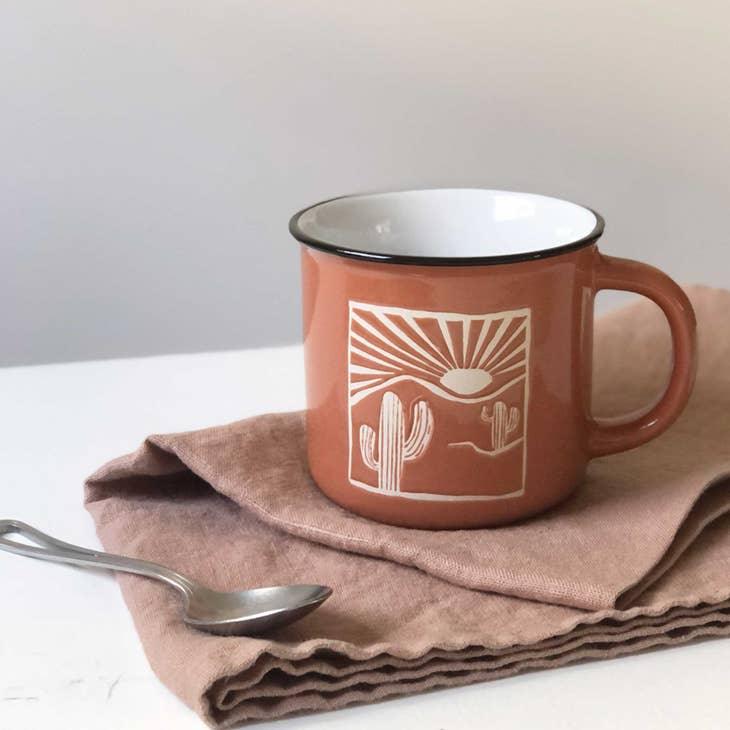 A durable Desert Red Camping Mug, perfect for outdoor adventures, placed on a rustic wooden surface.