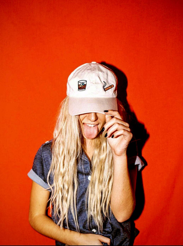 Person wearing a white cap with a logo on a red background