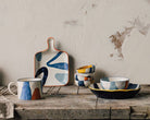 Canvas Stamped Tapas Plate with abstract mustard yellow, navy blue, and light blue patterns.