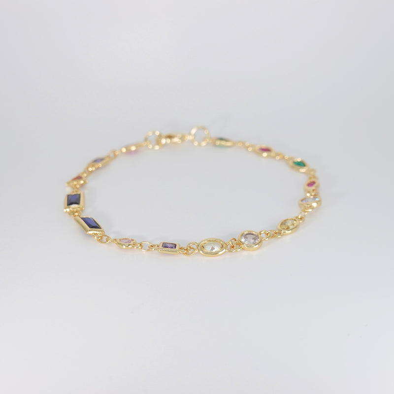 Blossom Bracelet: Gold chain bracelet with colorful gemstones cascading down.