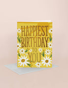 Birthday card with 'Happiest Birthday to You' text and daisy flowers on a yellow background
