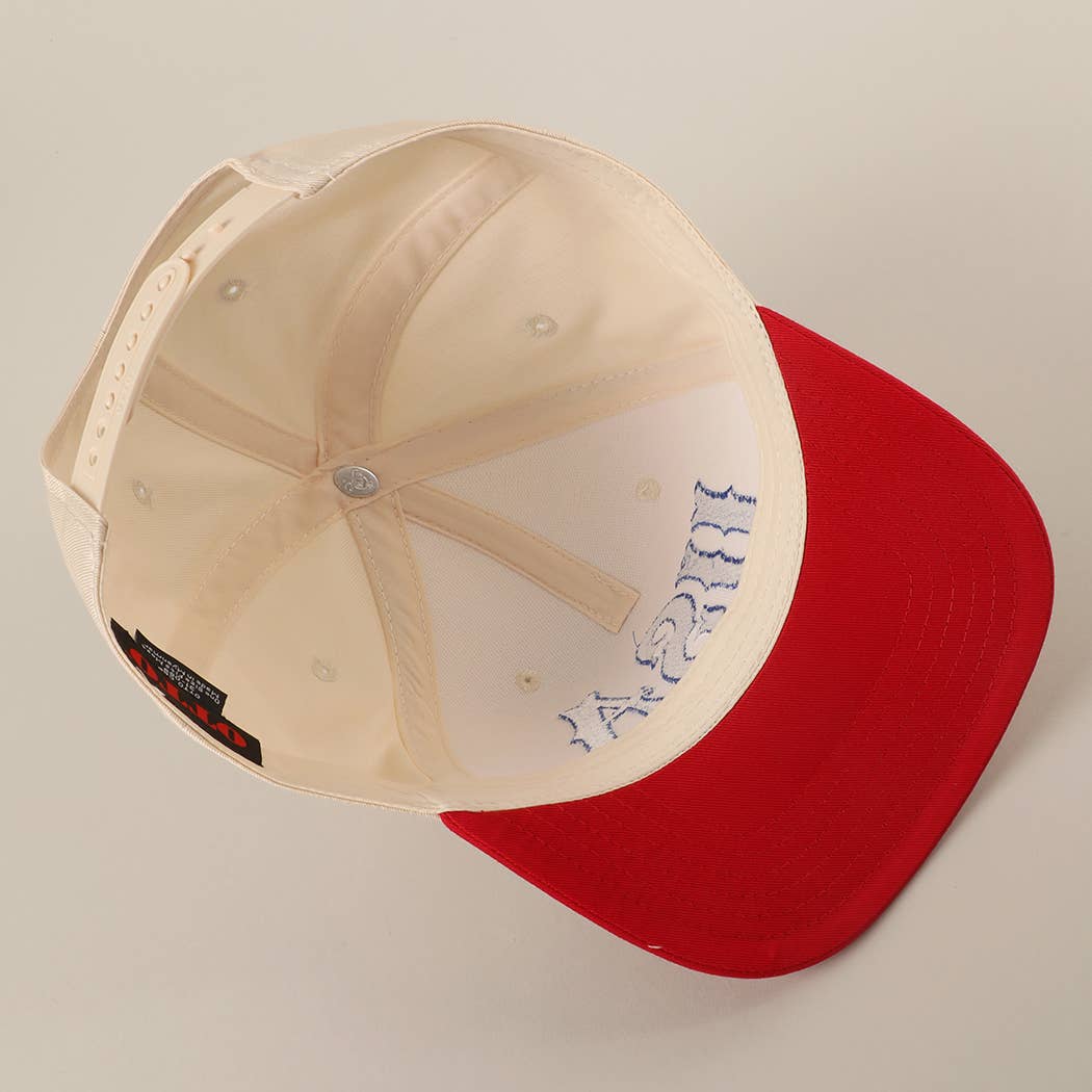 Beige and red cap with a logo on a beige background