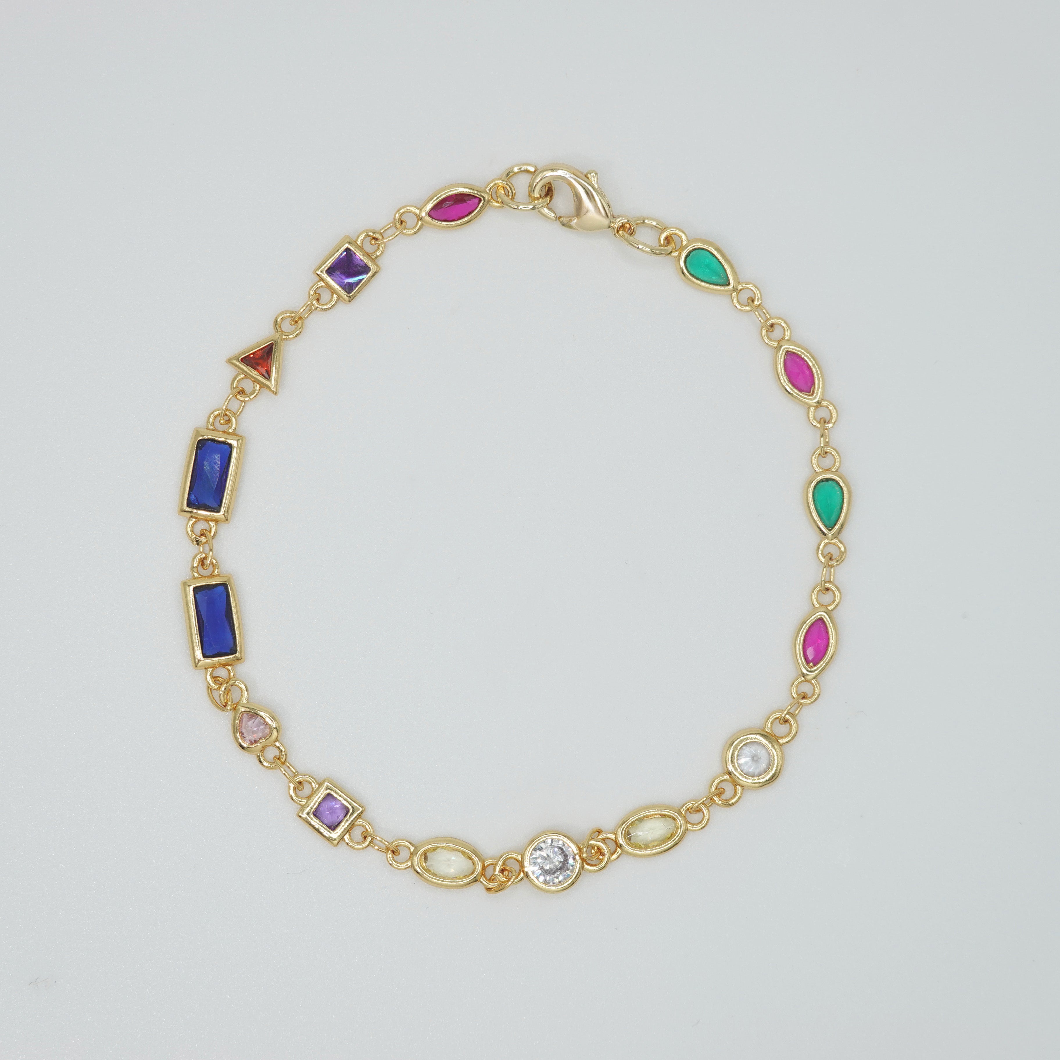 Blossom Bracelet: Gold chain bracelet with colorful gemstones cascading down.