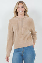 Woman wearing a beige ultra-soft hoodie with a drawstring hood.