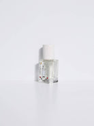 Maison Matine Avant l’Orage perfume bottle with celestial illustrations, placed among citrus fruits and sample vials on blue fabric