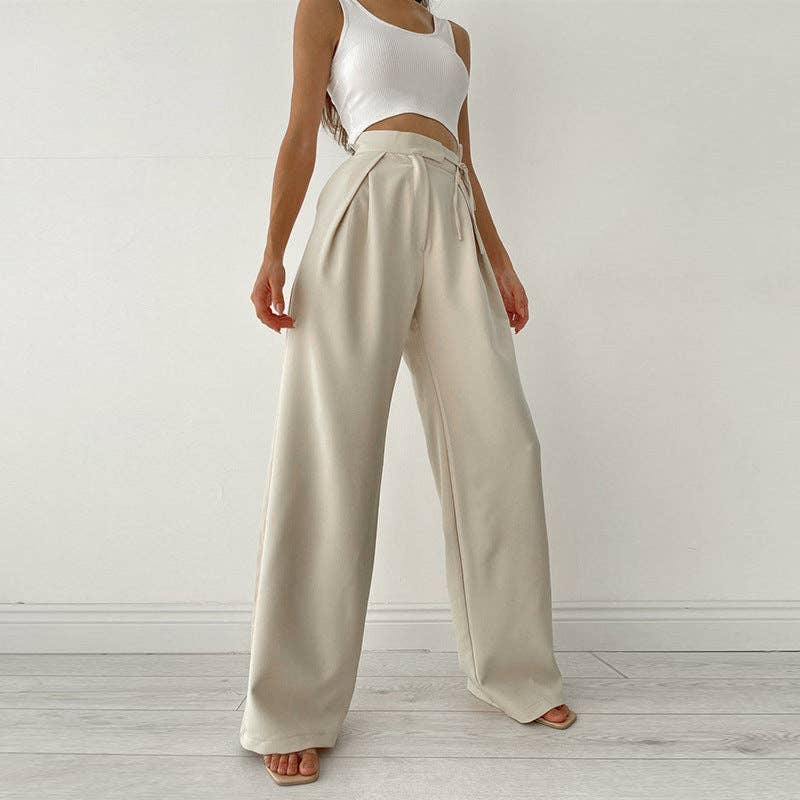 Woman wearing Urban Elegance Palazzo Pants in cream color with a white crop top.