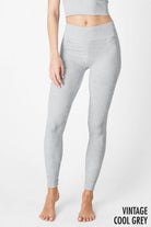 Woman wearing Serenity High-Waist Ribbed Leggings in vintage cool grey, featuring a high-rise waistband and ribbed texture for a sleek, supportive fit.