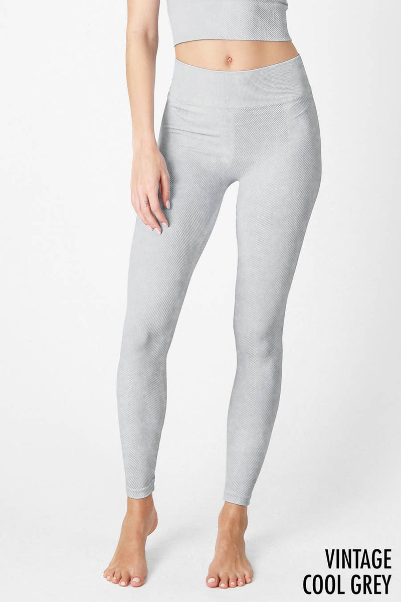 Woman wearing Serenity High-Waist Ribbed Leggings in vintage cool grey, featuring a high-rise waistband and ribbed texture for a sleek, supportive fit.