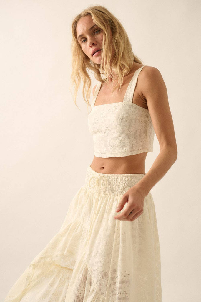 Model wearing ivory lace two-piece set with cropped top and drawstring wide-leg pants.