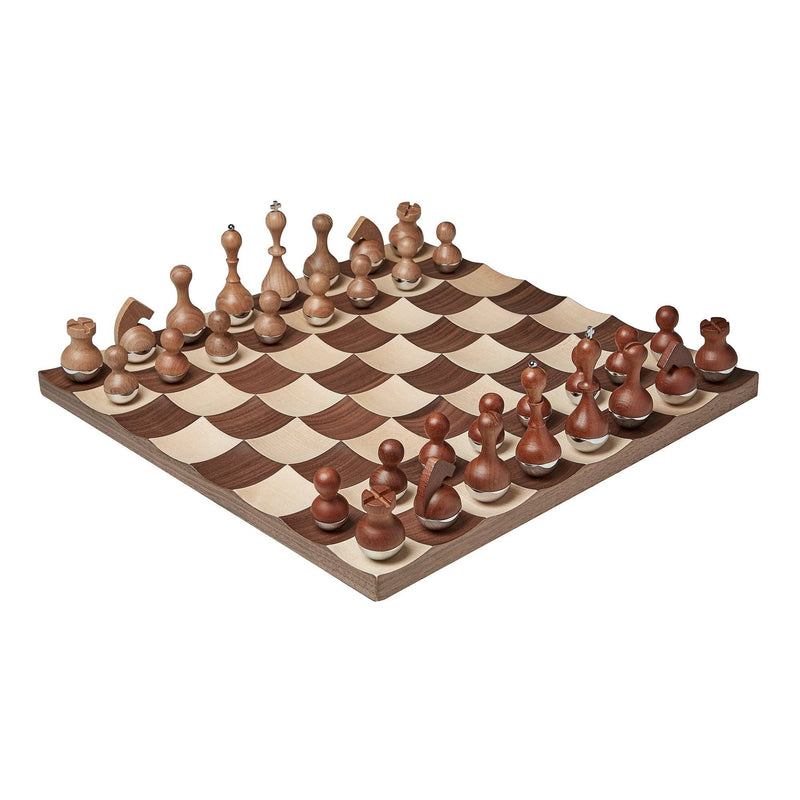 Modern wobble chess set with rounded-bottom wooden pieces and curved maple and walnut board.