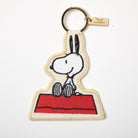 Embroidered Snoopy keychain with Snoopy sitting on a red doghouse.