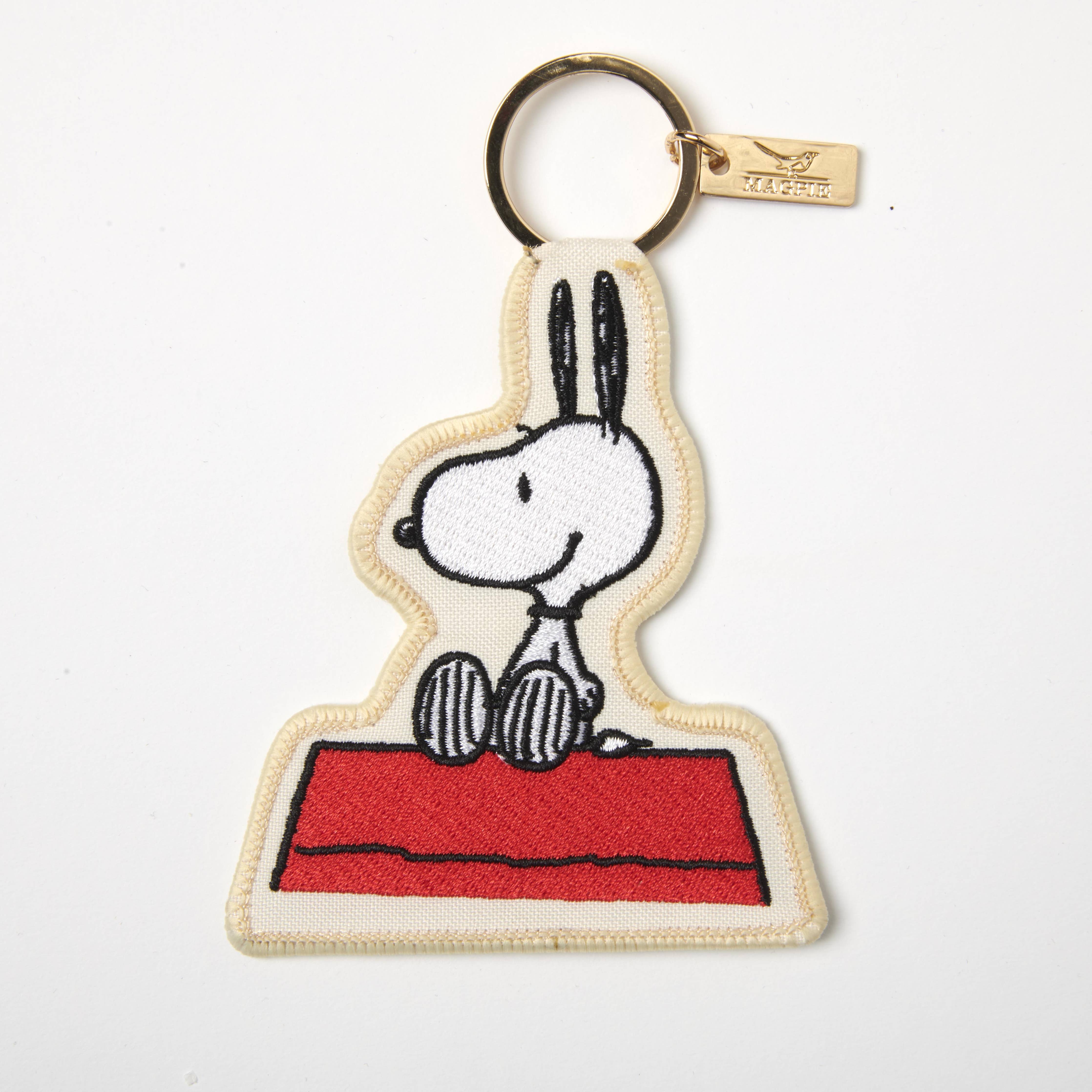 Embroidered Snoopy keychain with Snoopy sitting on a red doghouse.