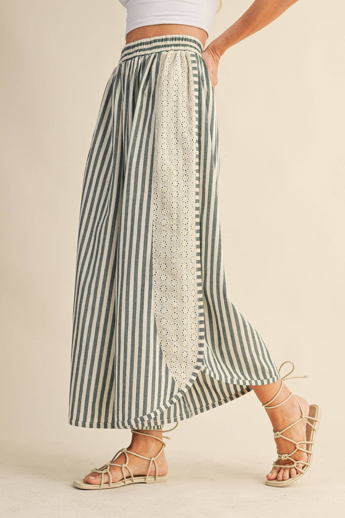Striped wide-leg pants with floral eyelet side panels and elastic waistband, styled with a white crop top