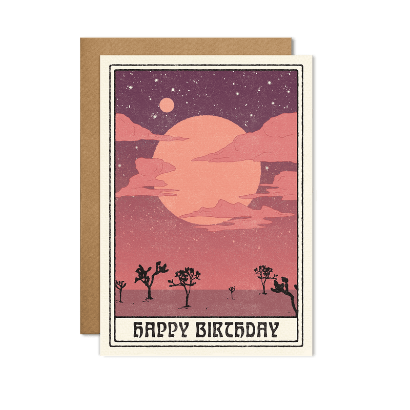 Happy Birthday card featuring a dreamy desert scene with a Joshua tree and a large moon against a starry purple and pink sky.