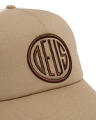 Beige cap with a brown logo on a white background
