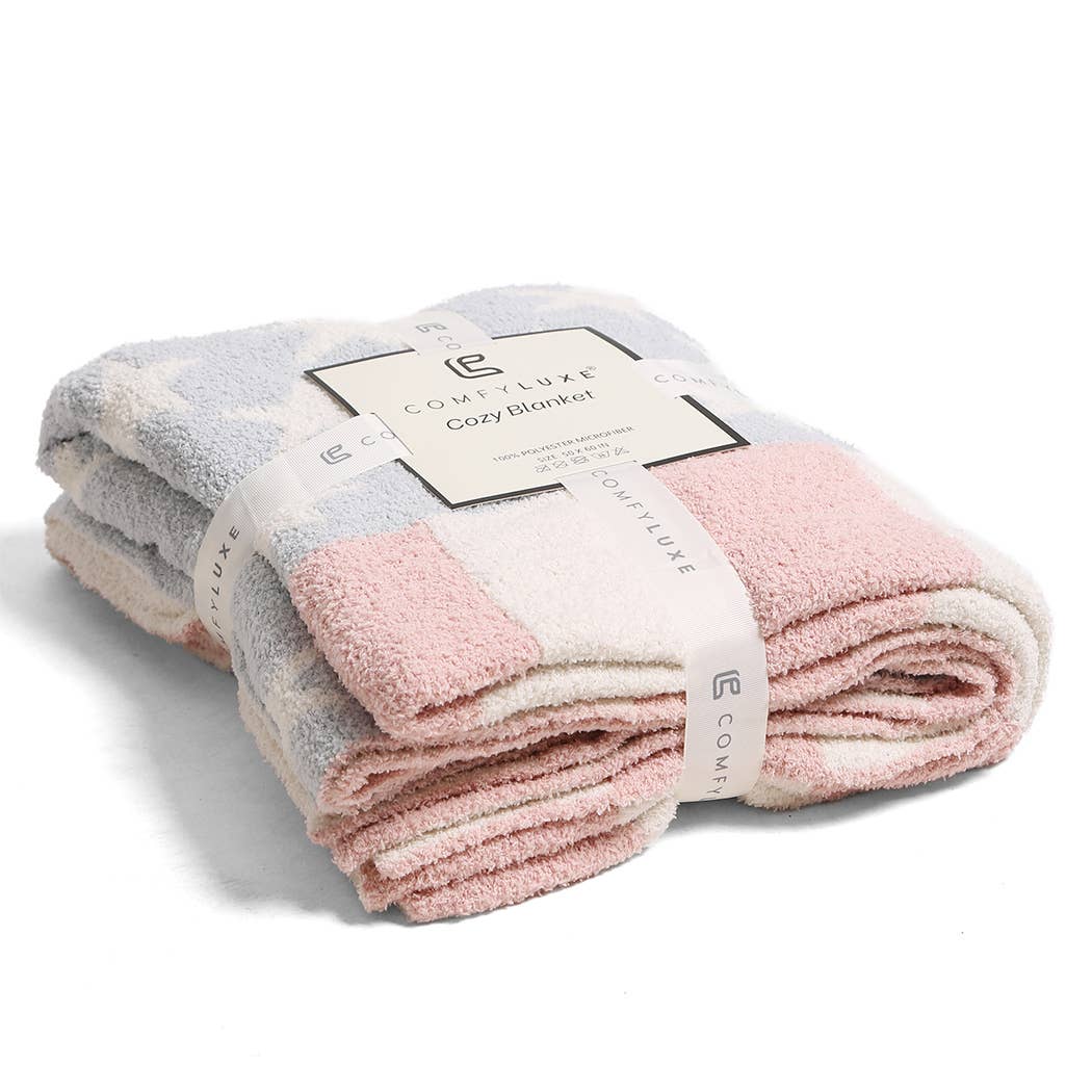 Folded pink and gray blanket with a Comfy Luxe label on a white background