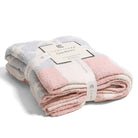 Folded pink and gray blanket with a Comfy Luxe label on a white background