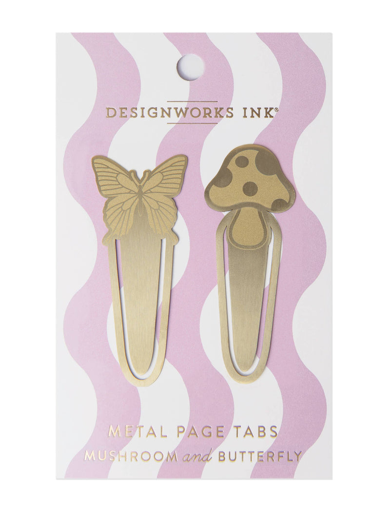 A set of two brass metal page tabs in butterfly and mushroom shapes, packaged on a pastel pink and white wavy background.