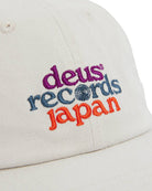 White cap with colorful embroidered text on a white background