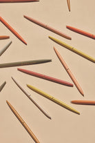 "Positivity" slim metal pen set of four in assorted bright colors, each featuring an inspirational message, packaged in a mint green box.
