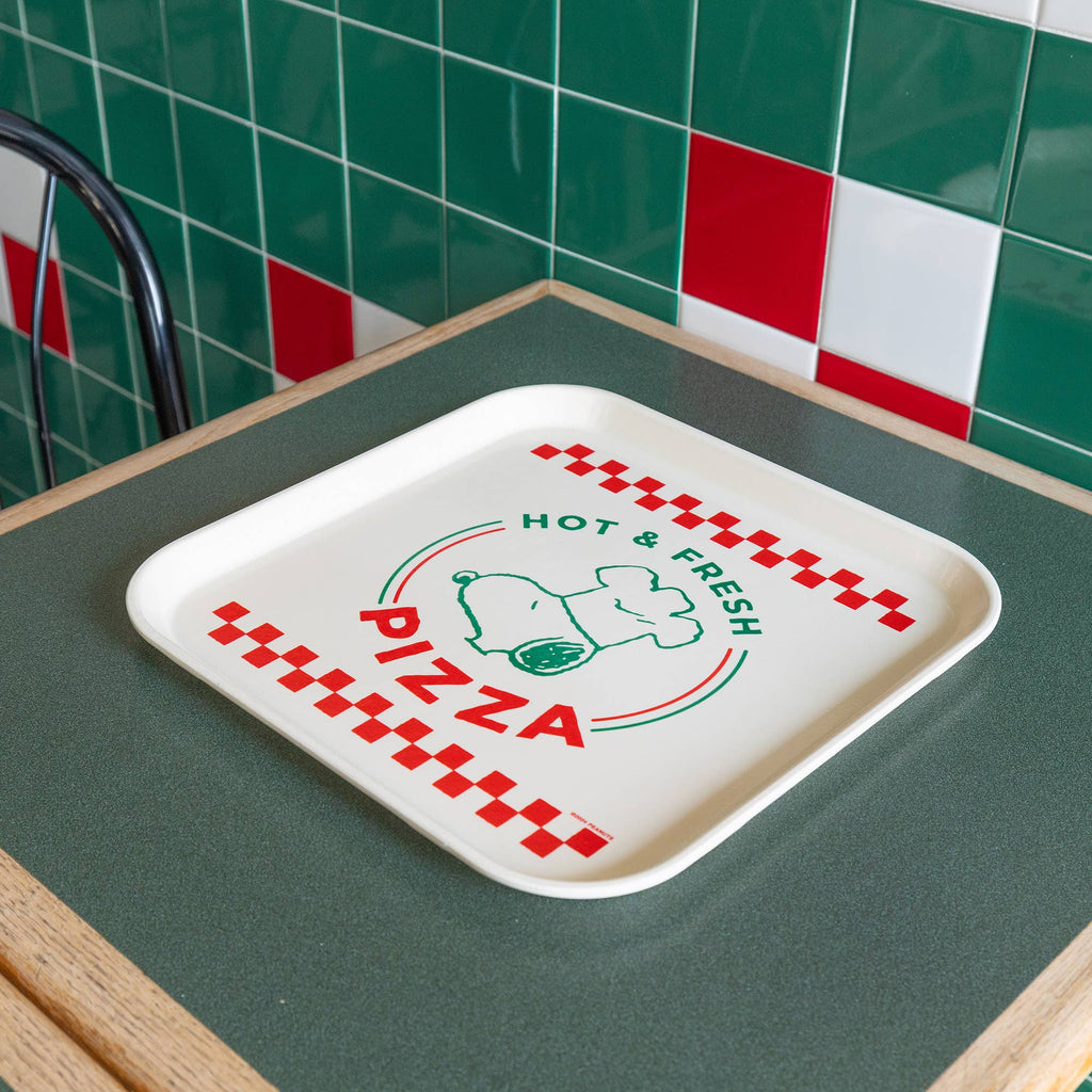 Square cream-colored tray with a green outline of Snoopy wearing a chef’s hat, red checkered accents, and the words “Hot & Fresh Pizza.”