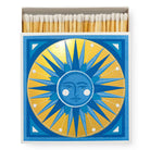 A square matchbox featuring a golden sun design.