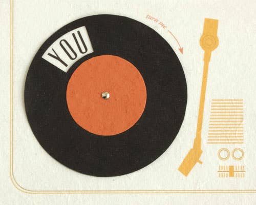 Vinyl record with 'YOU' text on a beige background