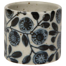 Ceramic cup with blue floral pattern on a white background