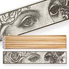 A long matchbox adorned with wide-eyed motifs.