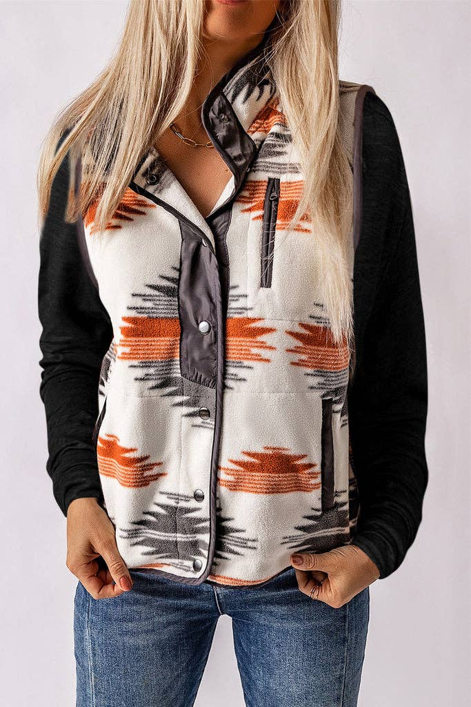 Model wearing an Aztec Western Fleece Vest Jacket with a bold pattern, snap-button front, and zippered pockets.