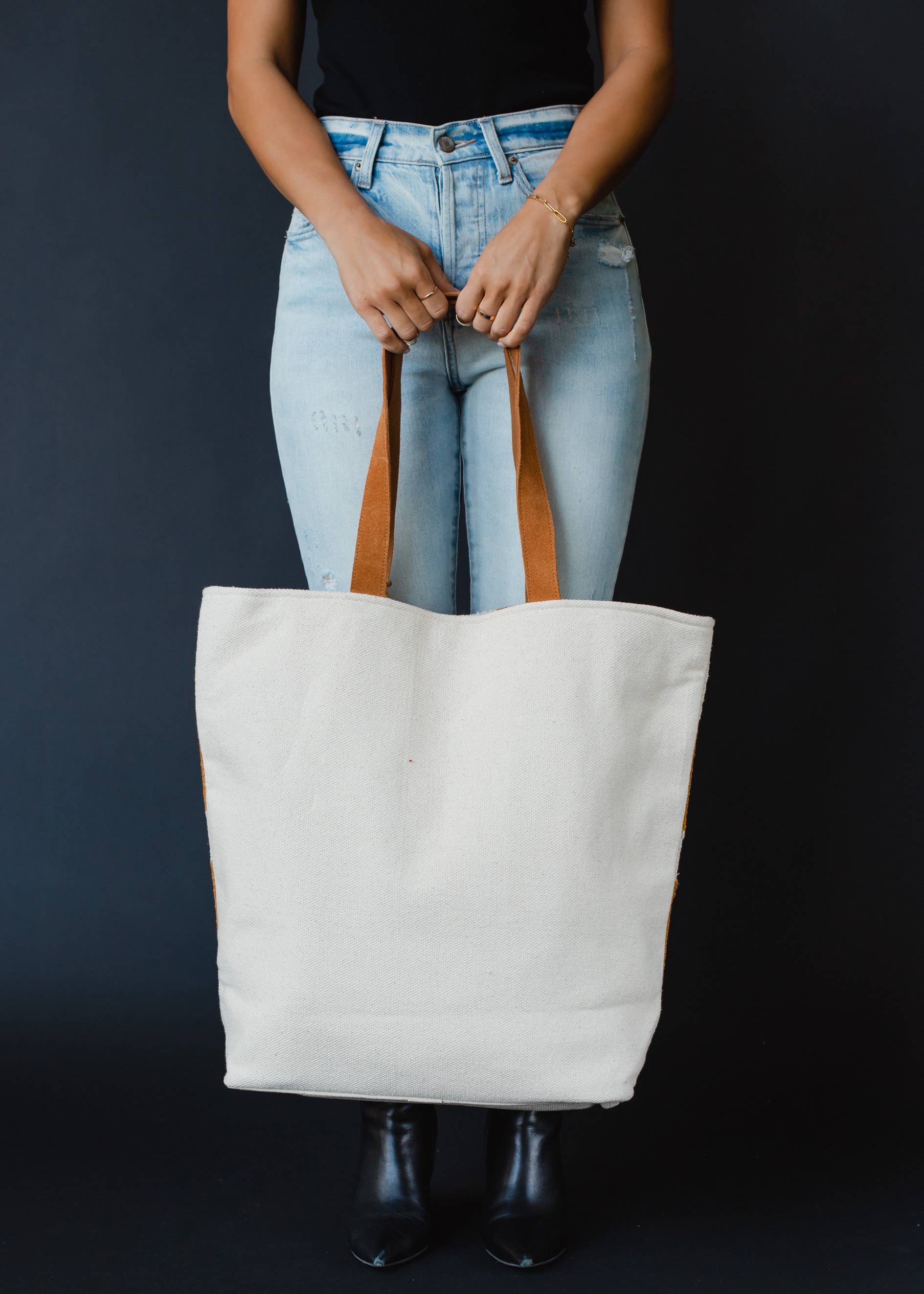 Large mustard and ivory woven tote bag with geometric pattern, leather handles, and a tassel accent