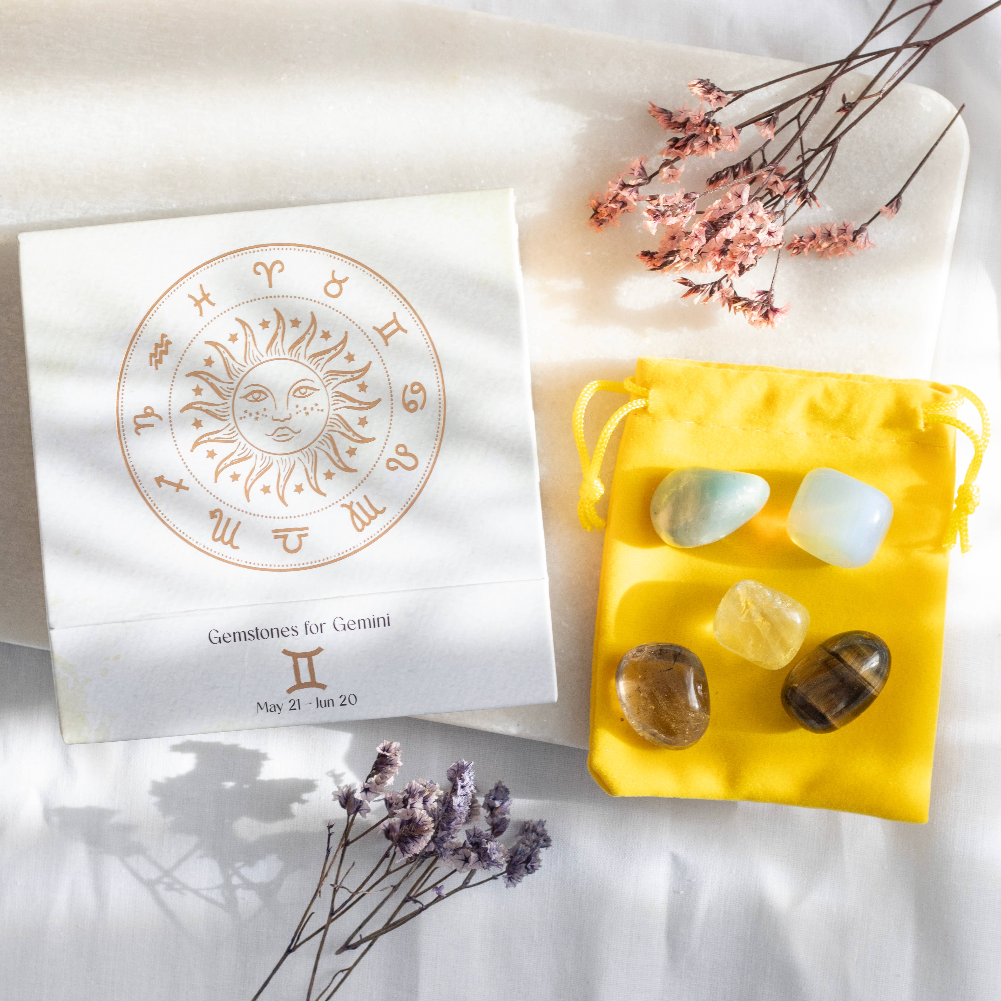 Gemini zodiac gemstone set with Lemon Quartz, Tiger’s Eye, Moonstone, Amazonite, and Smokey Quartz, displayed in a yellow pouch and decorative box.