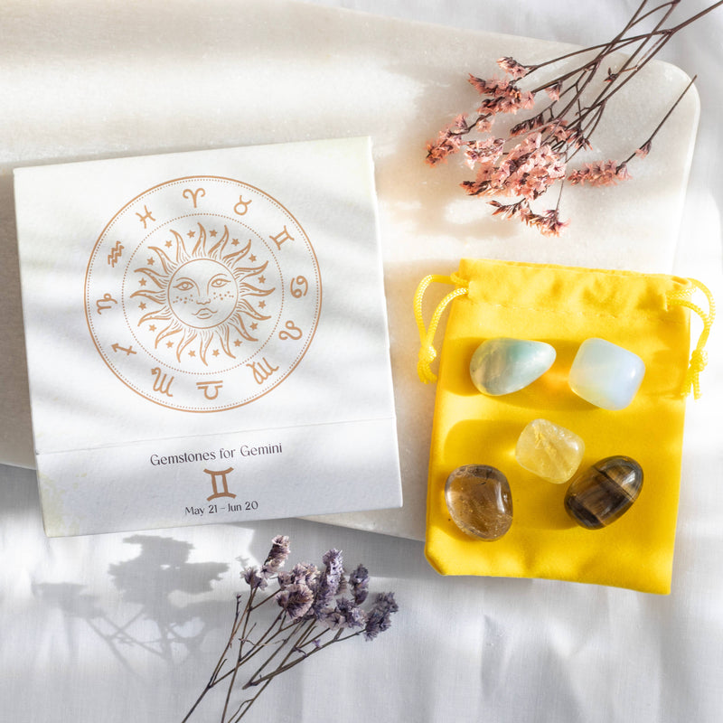 Gemini zodiac gemstone set with Lemon Quartz, Tiger’s Eye, Moonstone, Amazonite, and Smokey Quartz, displayed in a yellow pouch and decorative box.