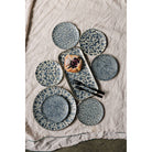Set of ceramic plates with a textured pattern on a textured surface