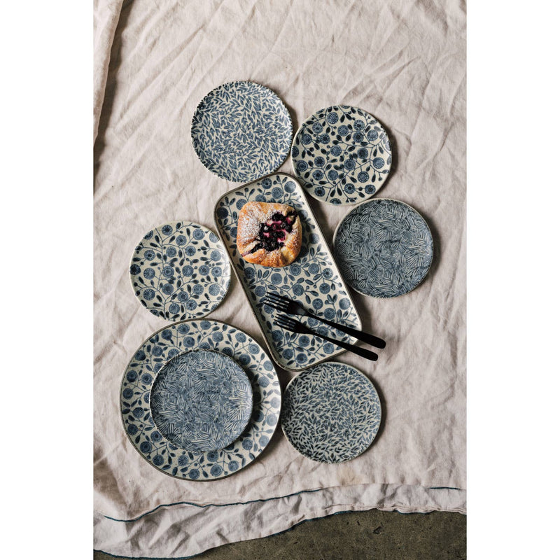 Set of ceramic plates with a textured pattern on a textured surface
