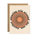 A greeting card with a retro-style sunburst design and the phrase "Another amazing trip around the sun" in bold, circular text.
